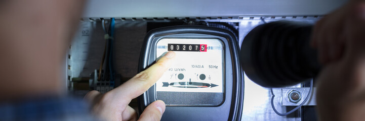 Finger Pointing To Electric Meter Reading - obrazy, fototapety, plakaty