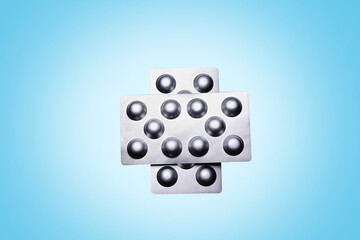 Set of medical tablets and pills in pharmaceutical blister pack on blue