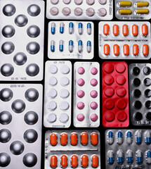 Close up of white and colorful medicines blisters pils and capsules. Medical background.