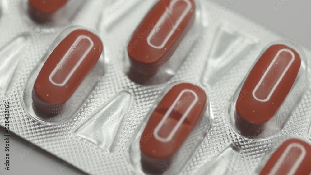Poster red capsules in a blister are rotated in a circle