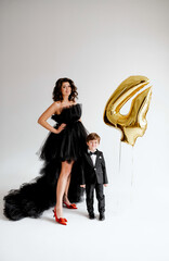 Woman at dress with son at suit