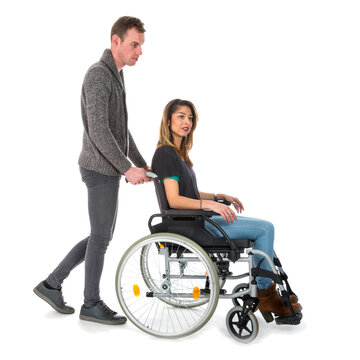 Man pushing woman in a wheelchair isolated on transparent background