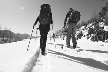 a group of mountaineers walking in the snow
