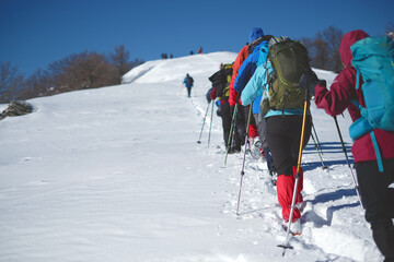 a group of mountaineers walking in the snow
