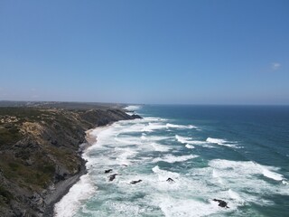 waves crashing on cliff