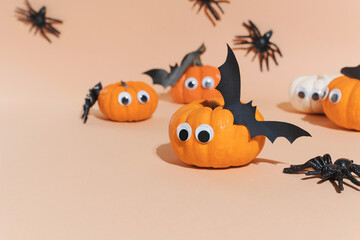 Halloween background. Decoration for Halloween party - cute pumpkins with eyes and funny faces. Set...