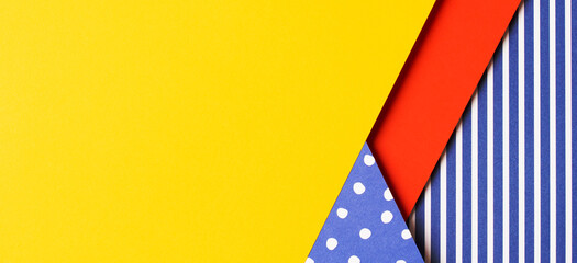 Texture background of fashion papers in memphis geometry style. Yellow, red, blue, white colors, striped and polka dot pattern. Top view, flat lay