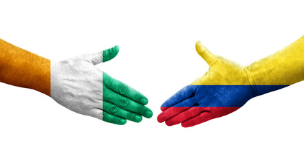 Handshake between Colombia and Ivory Coast flags painted on hands, isolated transparent image.