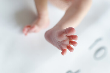 Newborn foot closeup from top. Cute fingers opened