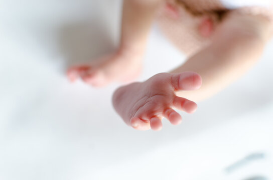 Newborn foot closeup from top. Cute fingers opened