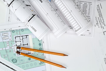 Working tools and drawings of the designer on a white background. Construction of houses, drawing, interior design.