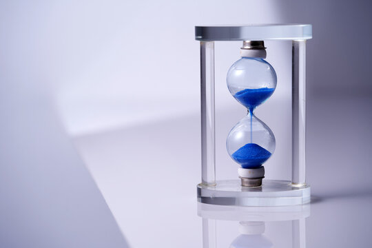 Hour Glass Against White Background With Reflection