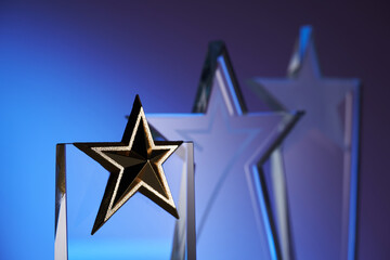 group of star shape crystal trophies against blue and pink background