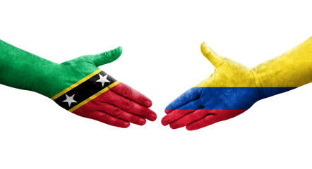 Handshake between Colombia and Saint Kitts and Nevis flags painted on hands, isolated transparent image.