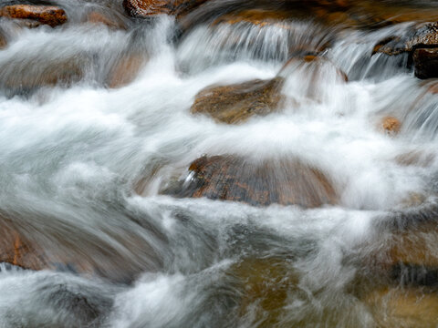 Babbling Creek With Water Rushing Over Polished Rocks