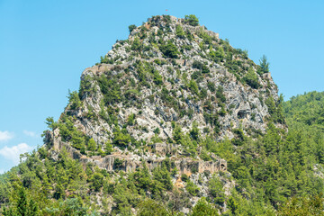 A massive rocky hill with the ruins of Alara Castle in Alanya, Turkey.