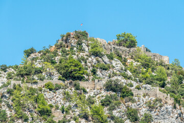 Ruins of Alara Castle sitting on a massive rocky hill in Alanya, Turkey.