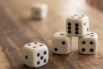 Plastic dice stacked on a wooden surface.