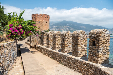 View of old harbour walls and Red Tower in Alanya, Turkey.