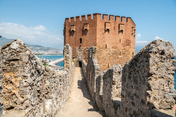 View of old castle walls and Red Tower in Alanya, Turkey.