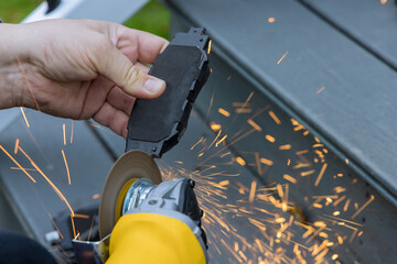Mechanic at car service center replaces brake pads system of vehicle