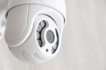 Security CCTV camera in office or shop building for protection against thieves, close up with copy space