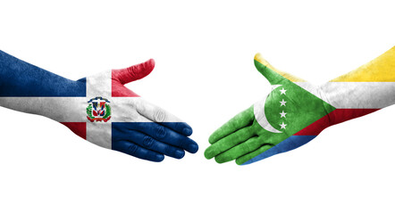 Handshake between Comoros and Dominican Republic flags painted on hands, isolated transparent image.