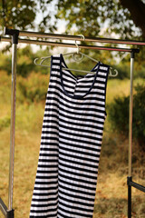 A striped summer dress hangs on a hanger.