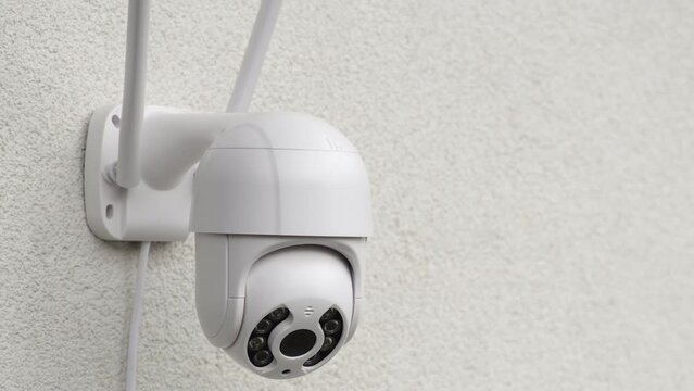 Round CCTV camera with antennas shoots video of workflow in shop closeup. Digital equipment to record and broadcast real time video closeup