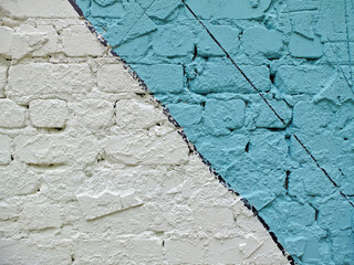 Colorful painted brick wall (blue, white and black) as background or texture