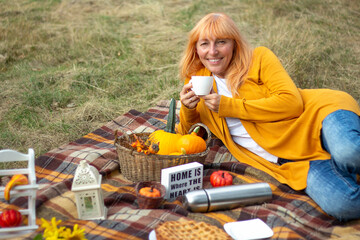 Thanksgiving Day. Thanksgiving Day Background from pumpkins. The girl lies holding a white cup in...