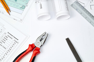 Working tools and drawings of the designer on a white background. Construction of houses, drawing, interior design.