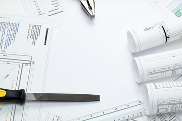 Working tools and drawings of the designer on a white background. Construction of houses, drawing, interior design.