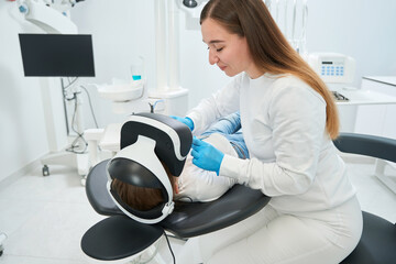 Stomatologist examining kid teeth using dental instruments