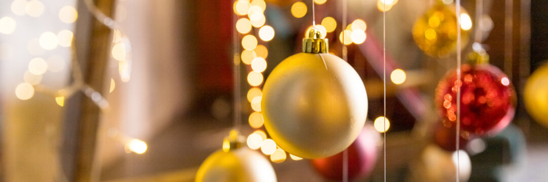 New Year Tree Art Installation Made With String Lights And Christmas Balls Hanging On Threads On Blurred Background.christmas Ornaments Hanging On The Rope. Web Banner