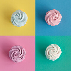 Collage of  colorful homemade Marshmallows or Zephyr on colored background. Top view.  Flat lay. Pink and sweet dessert image. Meringue Pavlova