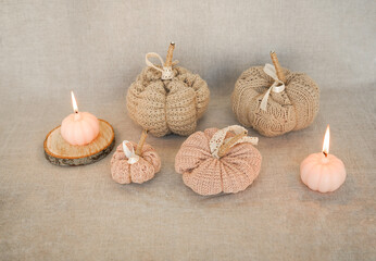Hobby background with handmade knit pumpkins and white pearl beads. DIY, craft decoration for fall and winter holidays.