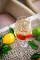 Summer alcoholic cocktail. Aperol lillet spritz with cherry, a beach refreshing cocktail at the bar