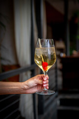 Summer alcoholic cocktail. Aperol lillet spritz with cherry, a beach refreshing cocktail at the bar