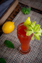 Alcoholic refreshing cocktail bloody mary with celery. Virgin mary cocktail served in a cup with celery sticks