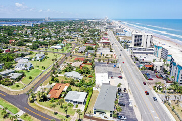Aerial looking north over Daytona Beach, Florida residential neighborhoods and the Intracoastal Waterway. on the left and beachfront hotels and condos on the right.