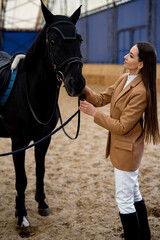 Countryside horse with female model. Young beautiful brunette girl rides a horse.