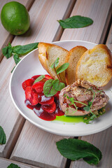 Chicken liver pate with croutons and strawberries in sweet sauce