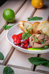 Chicken liver pate with croutons and strawberries in sweet sauce