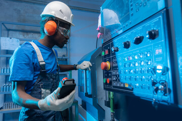 Professional african american engineer man in helmet uniform use CNC machinery, blue toning. Concept banner industry factory people