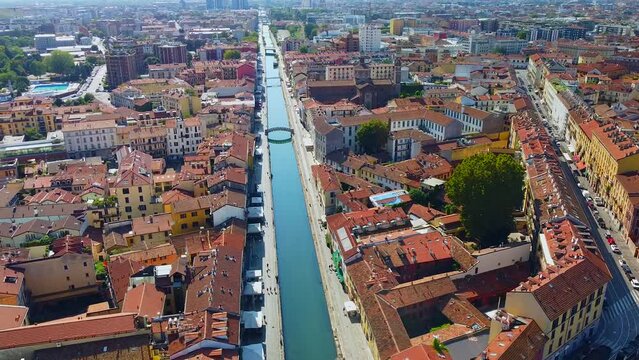 Aerial view of the water channels Navigli Milano and Porta Ticinese. Milano Darsena. Tourism. Public transport. Darsena freshwater canals in the city. Cars. Reflection. Milan Italy October 2022