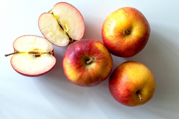 Fresh red apples whole and halves piece on a white background