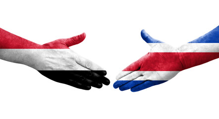 Handshake between Costa Rica and Yemen flags painted on hands, isolated transparent image.