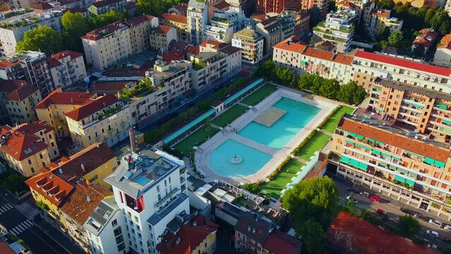 Bagni Misteriosi Aerial view of cityscapes and rooftops. New urban swimming pool with clear blue water.  Porta Romana. Skyline in skyscrapers. Milan Italy 10.2022