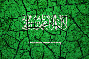 Dry soil pattern on the flag of Saudi Arabia. Country with drought concept. Water problem. Dry cracked earth country.	